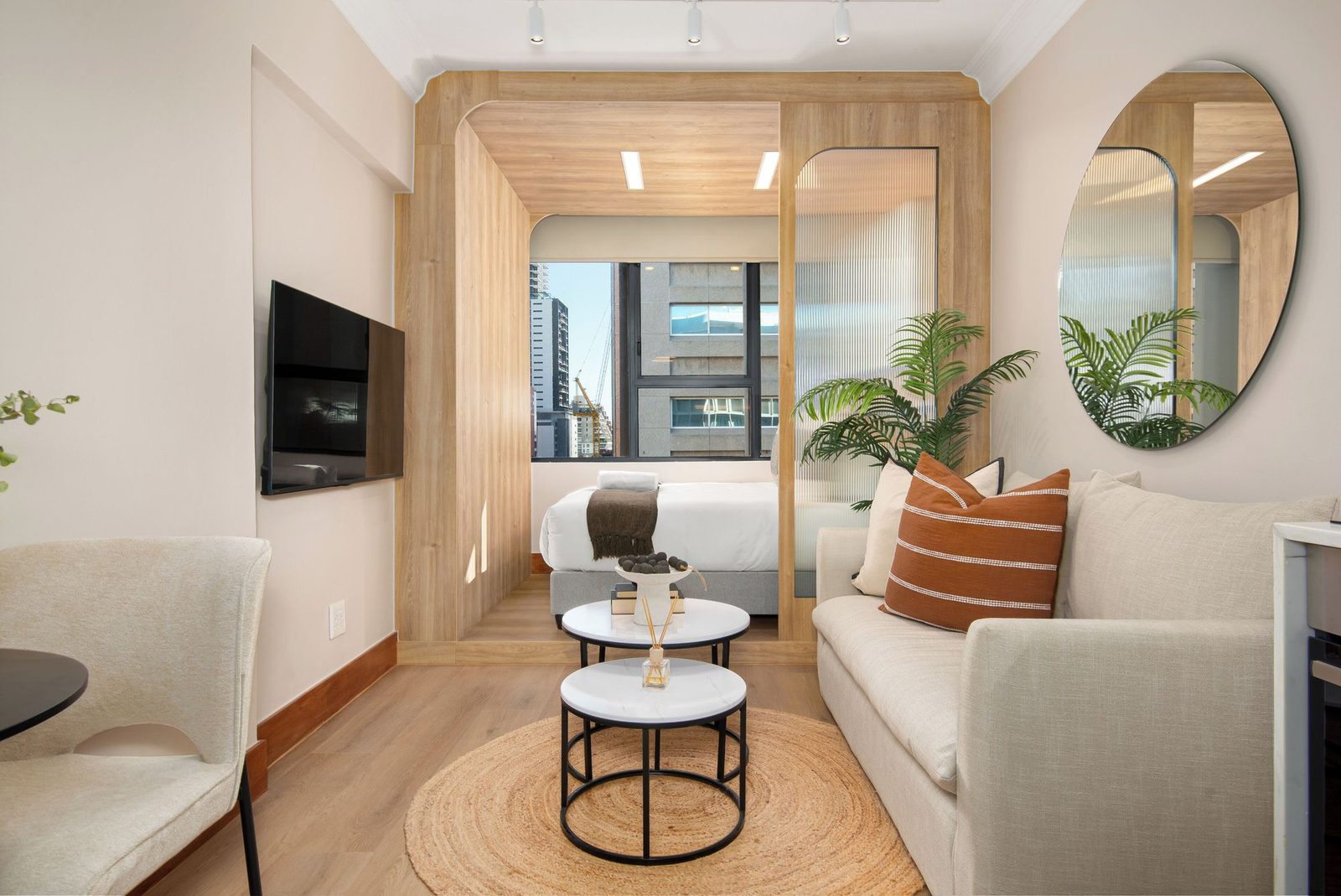 Studio apartment with an oak sleeping pod, fluted glass and a large round mirror