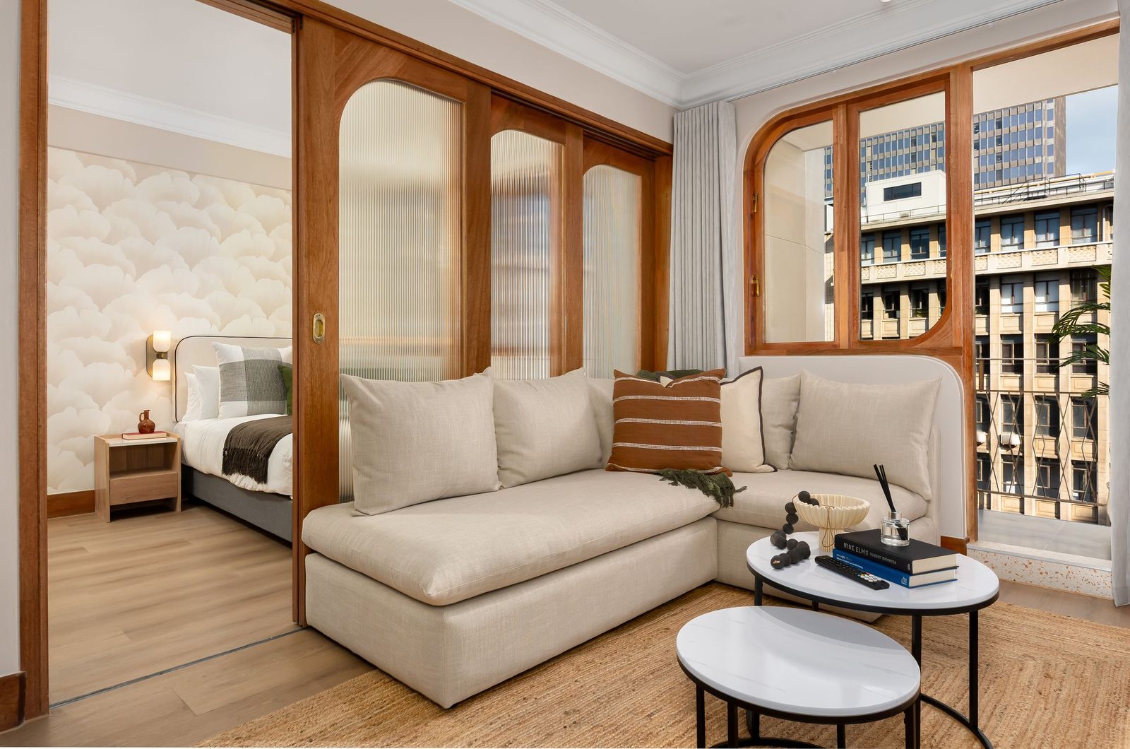 One-bedroom apartment with fluted glass sliding doors and an arched timber window